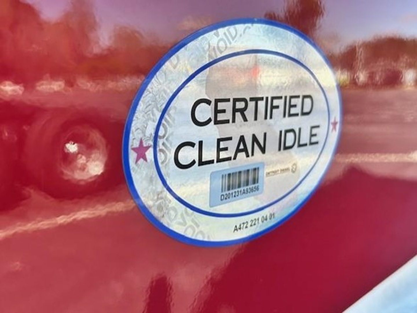 Sticker on Freightliner Cascadia showing Certified Clean Idle badge and barcode.