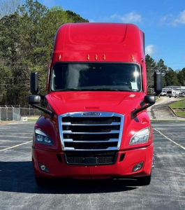 Freightliner Cascadia 126 front view in red with large grille, headlights, and side mirrors.