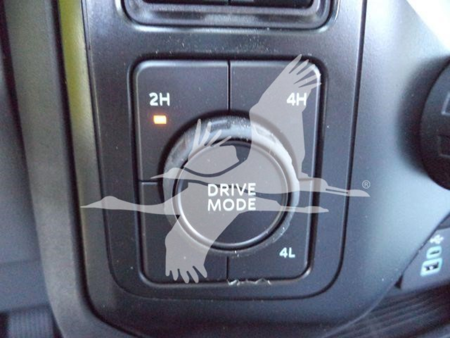 Dashboard drive mode selector showing 2H, 4H, 4L with 'DRIVE MODE' in center and partial '2H' and '4H' labels.