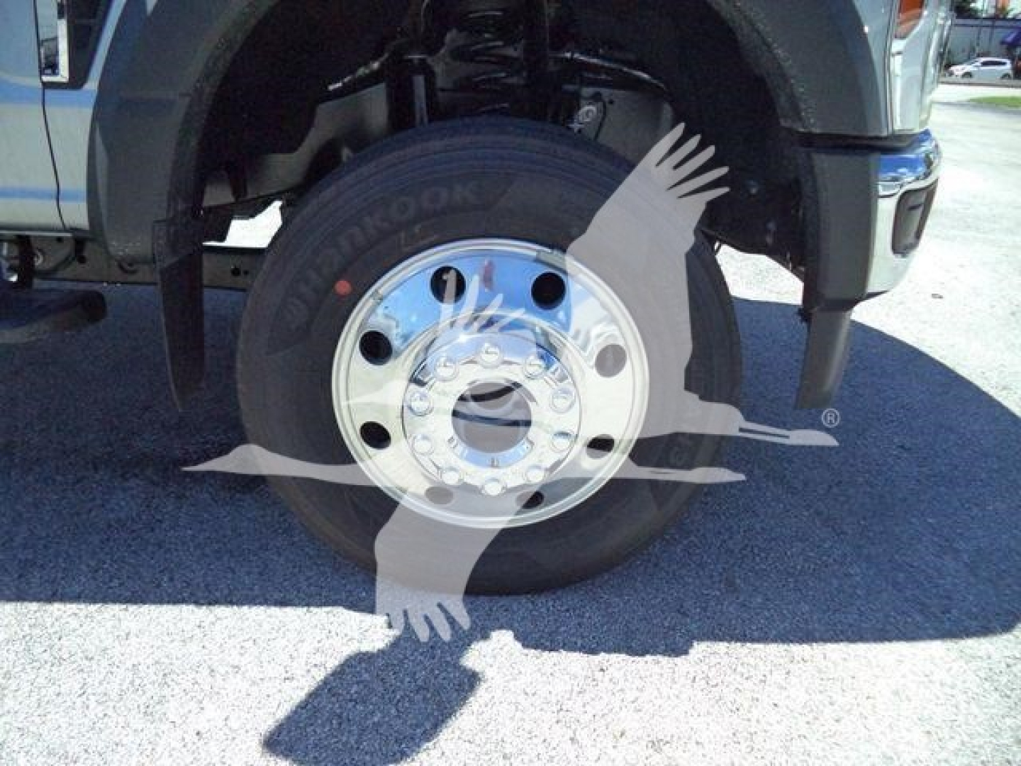 Ford F-Series truck front wheel and fender showing Hankook tire and polished steel rim, portion of chassis and suspension visible.