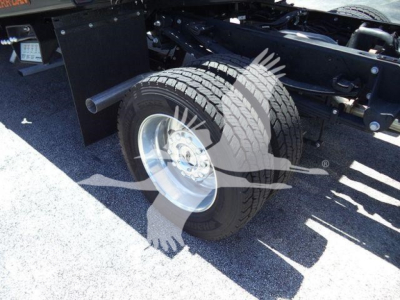 Rear section of a Ford F-Series chassis showing a dual rear wheel, suspension, and undercarriage with a watermarked logo overlay.