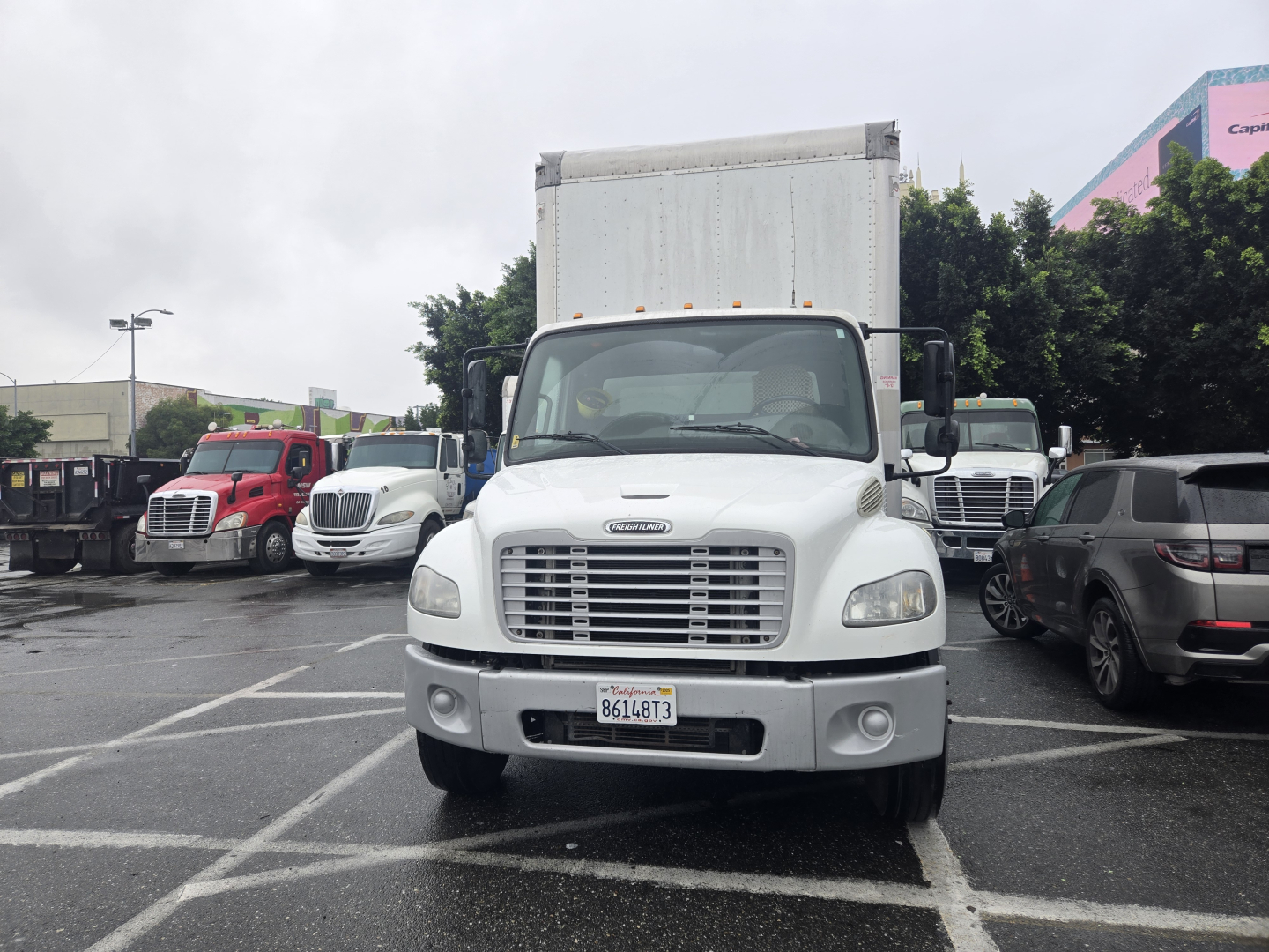 Front view of a white 2019 Freightliner M2 box truck in a parking lot.
