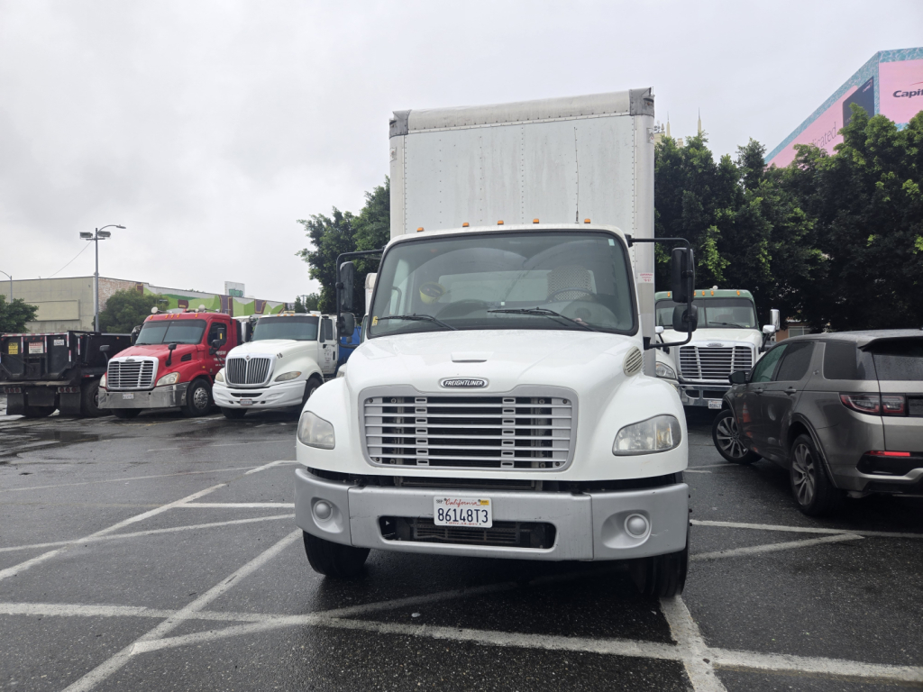 Front view of a white 2019 Freightliner M2 box truck in a parking lot.