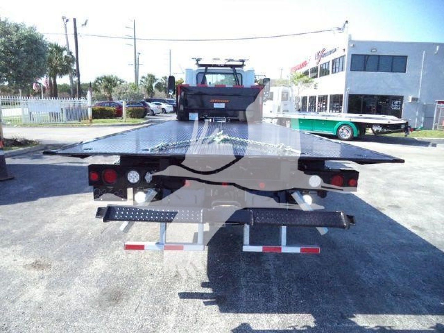 Md6 rollback tow truck flatbed from rear showing loading bed and deck overhang with tail lights and bumper; MD6 MDTUNNELBOX stock image.