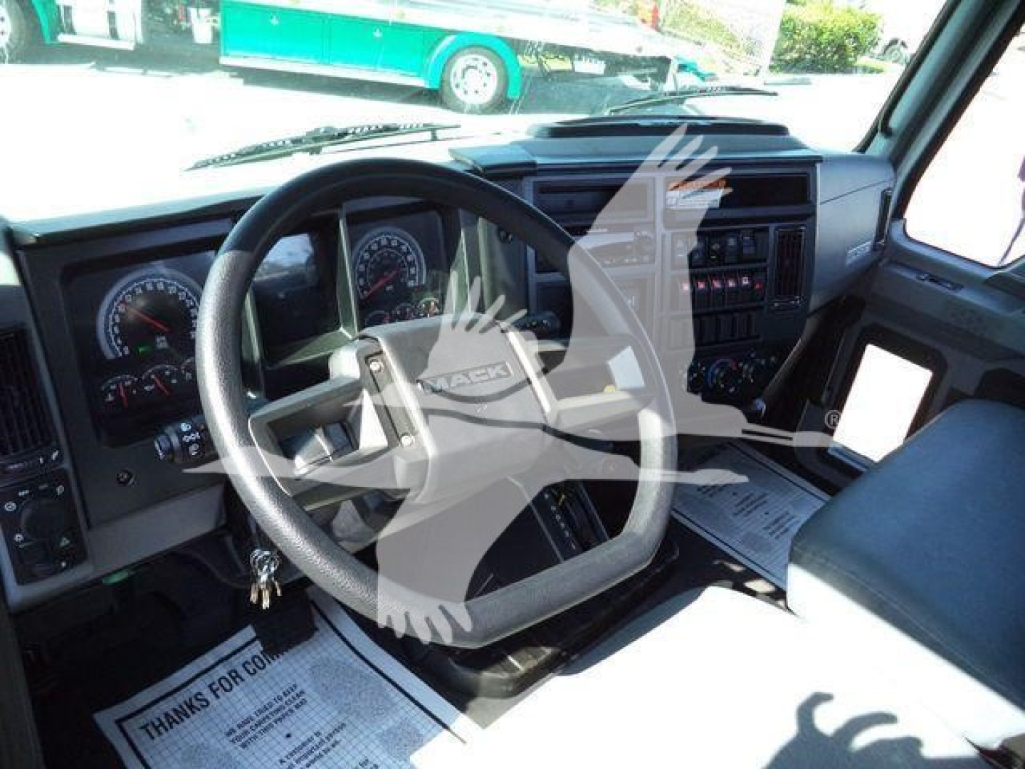 Mack MD6 truck interior showing steering wheel, dashboard gauges, and center console.