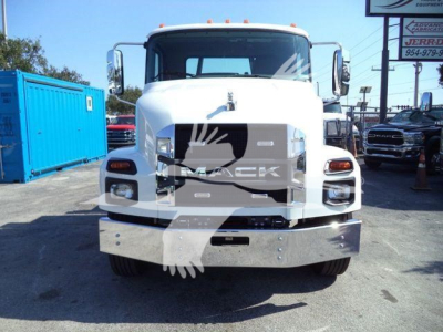Front view of a white 2026 Mack MD6 truck showing grille, bumper, and headlights in a dealership lot.