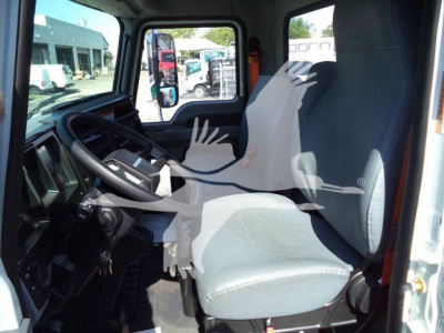 Interior cab of a 2026 Mack MD6 series truck showing driver's seat and steering wheel with dashboard view.