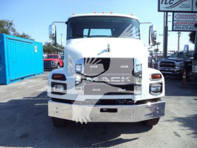 MD6-series Mack truck front view showing grille, headlights, and bumper in a dealership lot.
