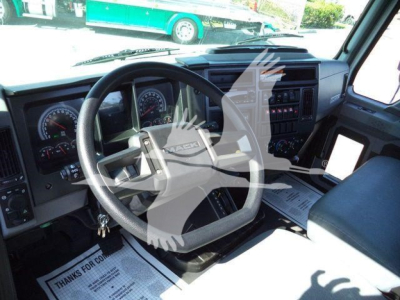 Mack MD6 truck interior showing steering wheel, dashboard gauges, and center console.