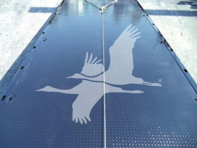 MD6 rollback trucks platform showing diamond plate surface with a flying bird graphic at center.
