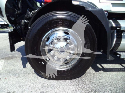 MD6 truck wheel and hub showing large steel rim and tire with mud flap visible.