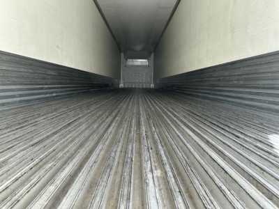 Trailer interior showing ribbed flooring and rear doorway in a used 2022 Utility 3000R reefer trailer.