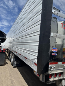 Utility reefer trailer side view showing ribbed aluminum siding and rear doors with Utility sticker and 3000R badge.
