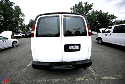 Rear view of a white 2008 Chevrolet Express 2500 extended van with dual rear doors and a visible license plate.