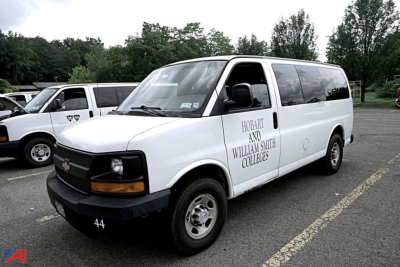 Chevrolet Express 2500 van in a parking lot showing Hobart and William Smith Colleges on the side window and the number 44 on the front bumper.