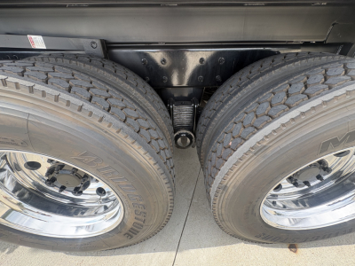 Mack GR84F dump truck dual rear tires and hitch area visible between wheels.