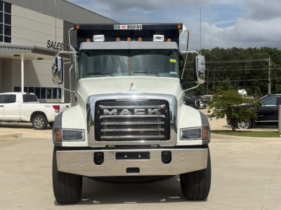 Front view of a white 2027 Mack GR84F dump truck showing bold grille, large bumper, and DPM headlights with Mack emblem.