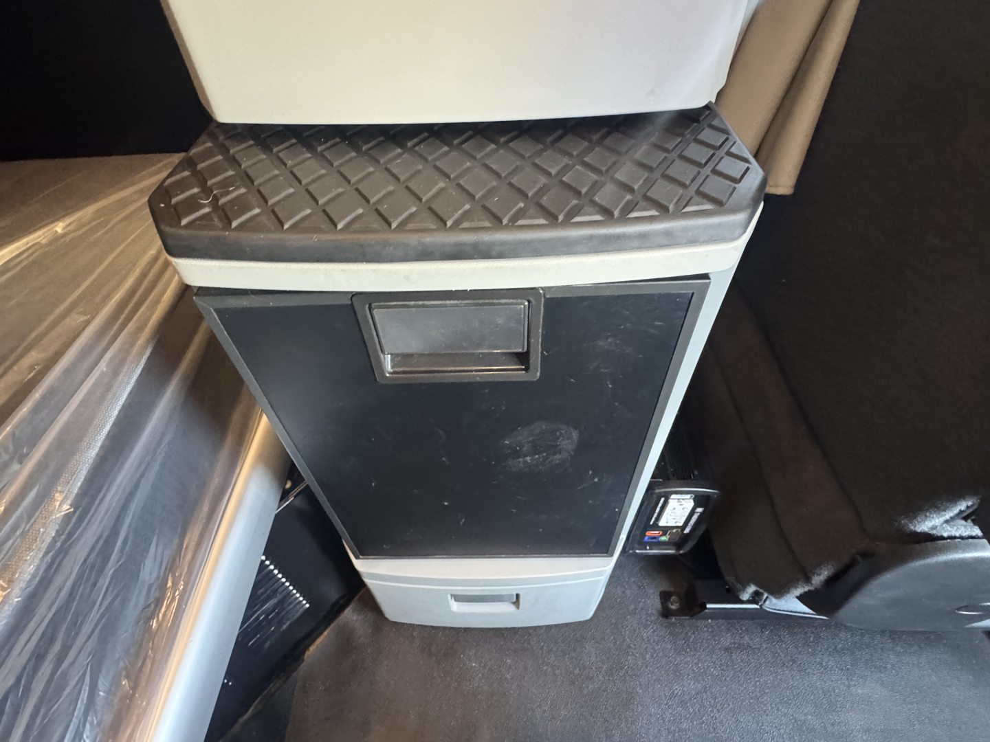 Kenworth T680 interior center console with storage drawer and textured lid.