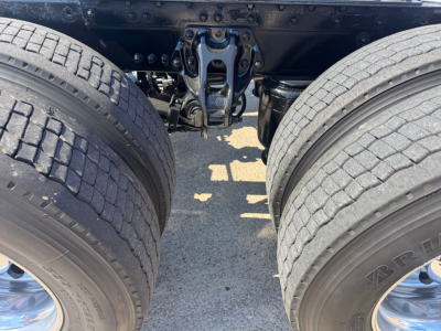 Kenworth T680 rear view showing dual rear axles and fifth wheel mounting area with suspension components visible.