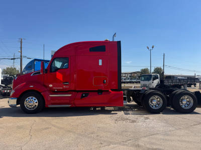 Kenworth T680 truck side view showing red sleeper cab and attached chassis with multiple rear axles.