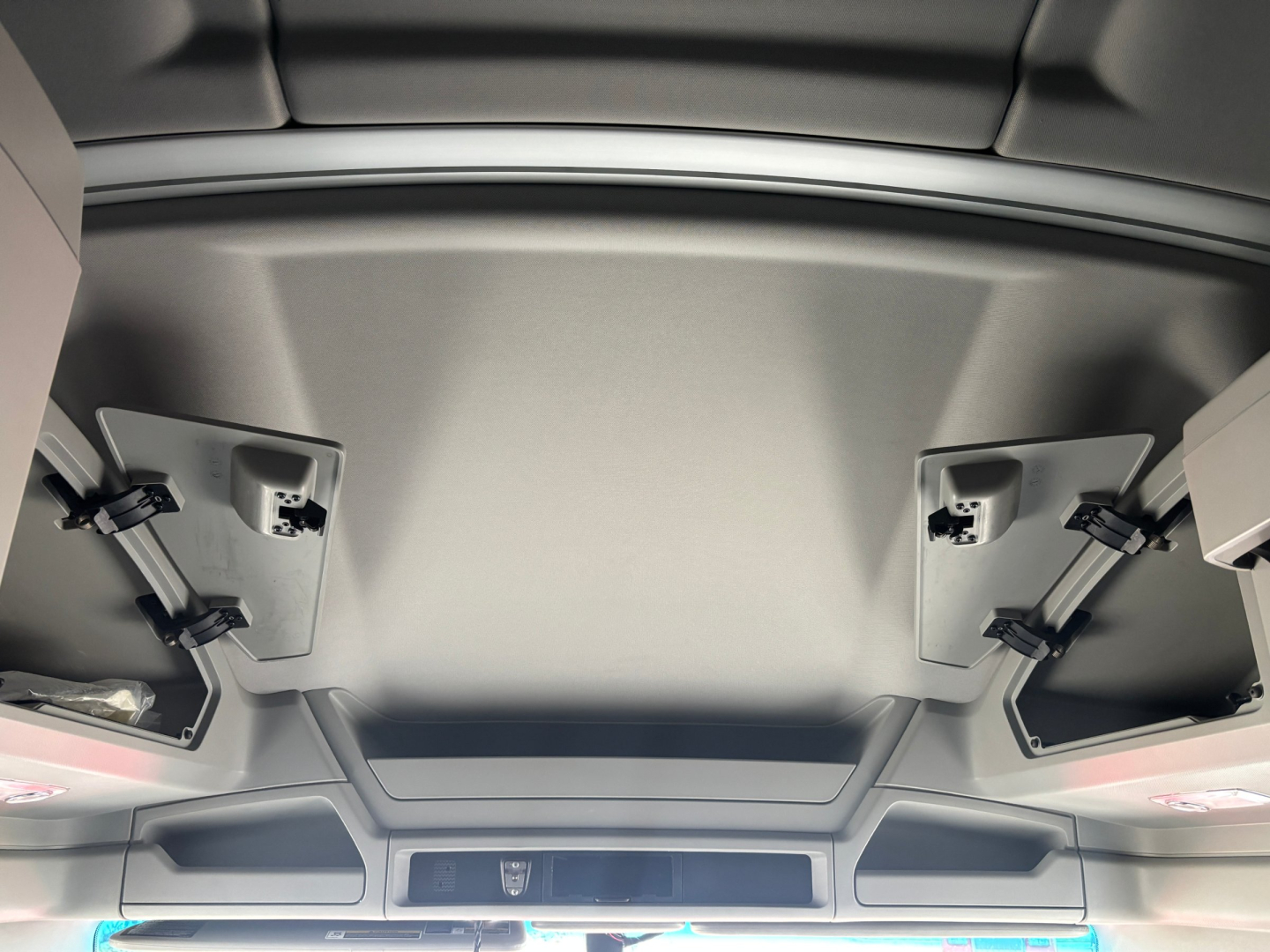 Kenworth T680 interior ceiling view showing overhead compartments and paneling.