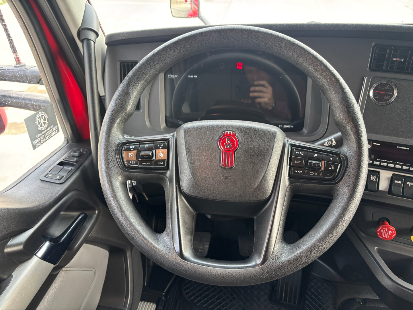 Kenworth T680 interior steering wheel with dashboard and controls; no legible vehicle specifications visible in the image.