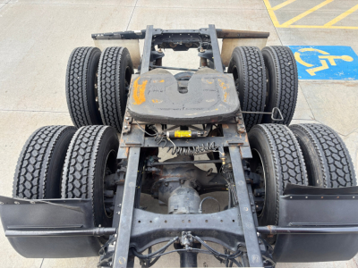 Kenworth T680 chassis with dual rear axles and twin dual tires, view from above showing frame and fifth-wheel area.