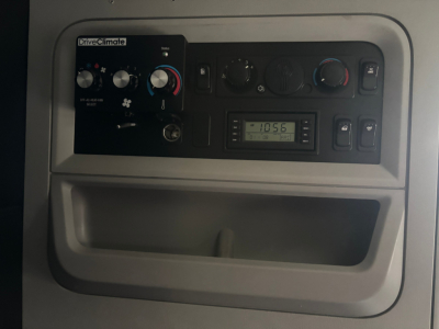 Kenworth T680 dash area showing Drive Climate control panel, gauges, and digital display inside cab.