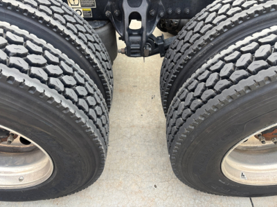 Kenworth T680 rear wheels and chassis showing dual rear axles and tires.