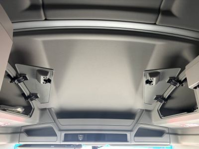 Kenworth T680 interior ceiling view showing overhead compartments and paneling.