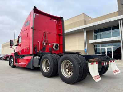 Kenworth T680 tractor rear and side view showing red cab, dual rear axles, and fifth wheel with white mud flaps.