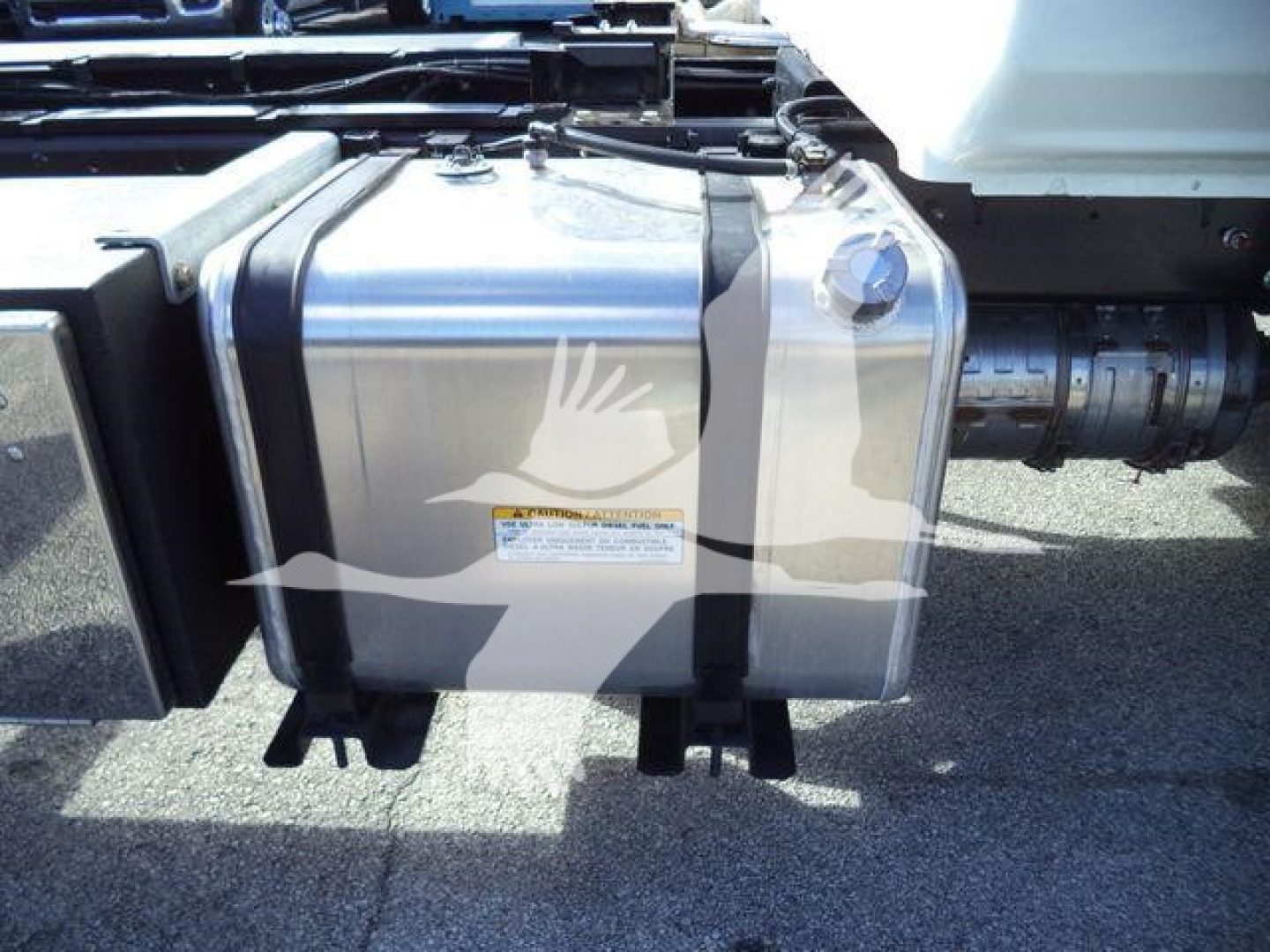 Fuel tank on a 2025 Hino 268A truck chassis side view with adjacent piping and frame components visible.