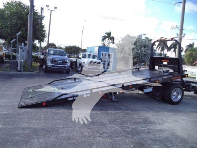 Flatbed rollback tow truck with hydraulic ramp on a lot, listed as 2025 Hino 268A.