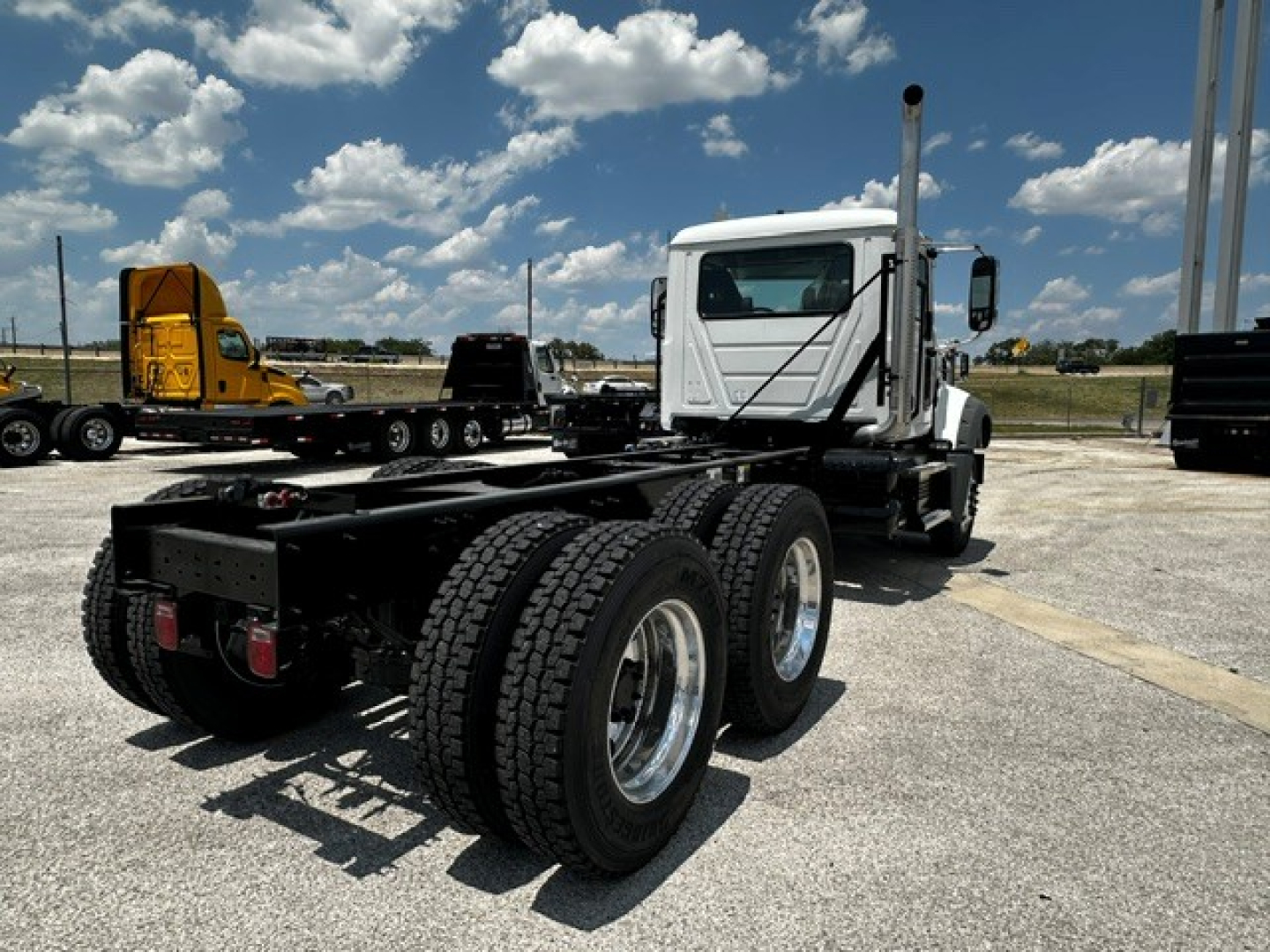 Chassis cab of a 2027 Mack GR64F showing rear axle dual tires and fifth wheel mounting area.