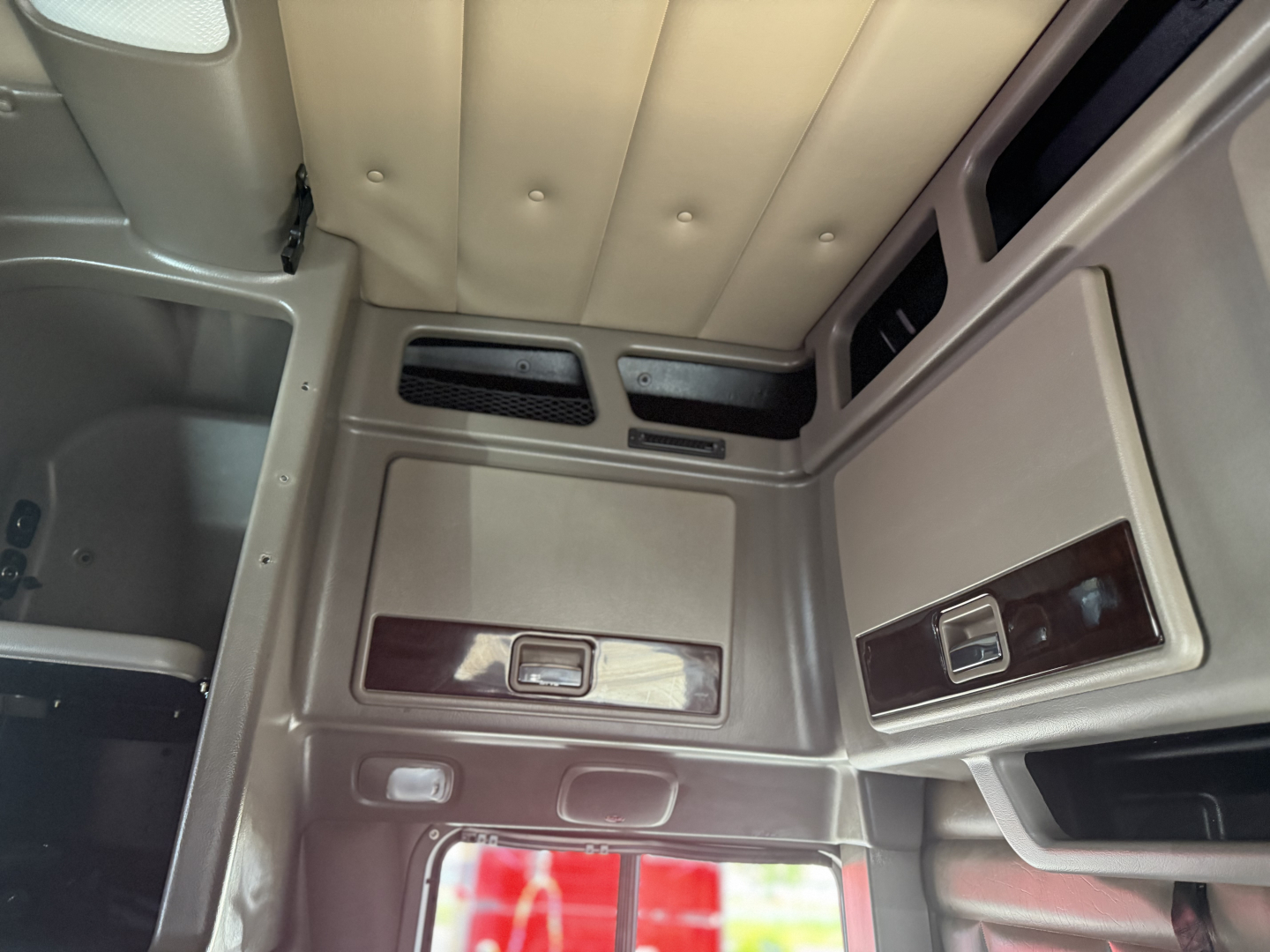 Peterbilt 389 cab interior showing storage compartments and vertical window panels.