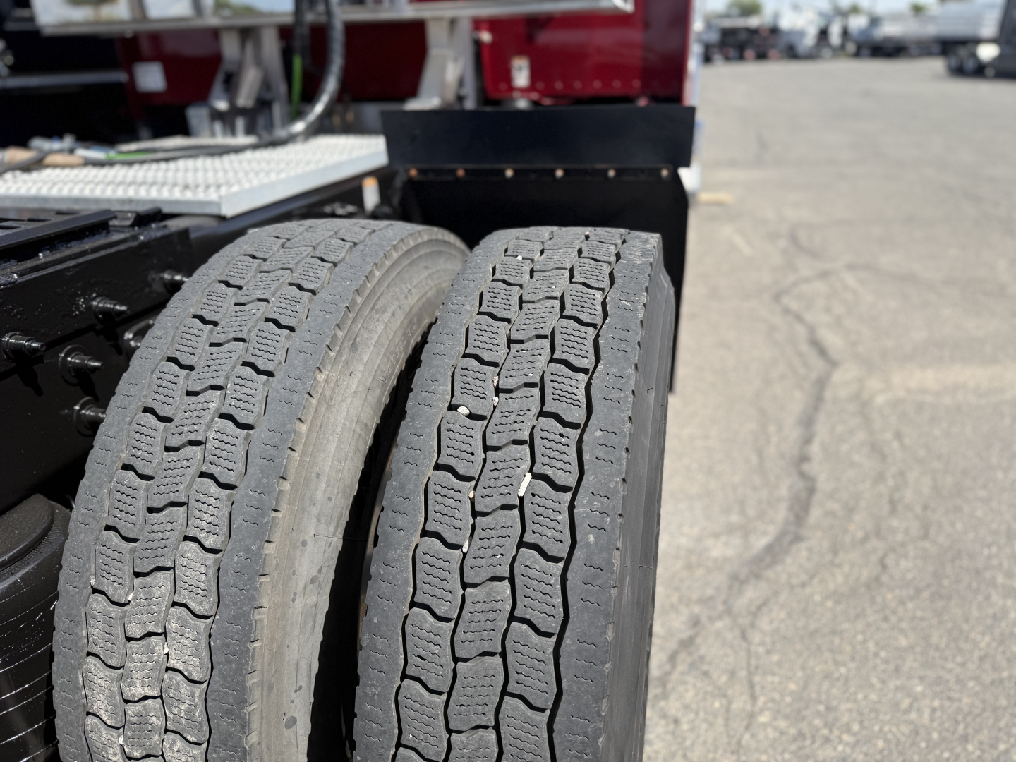 Dual rear tires of a Peterbilt 389 tractor show tread pattern and sidewall markings.