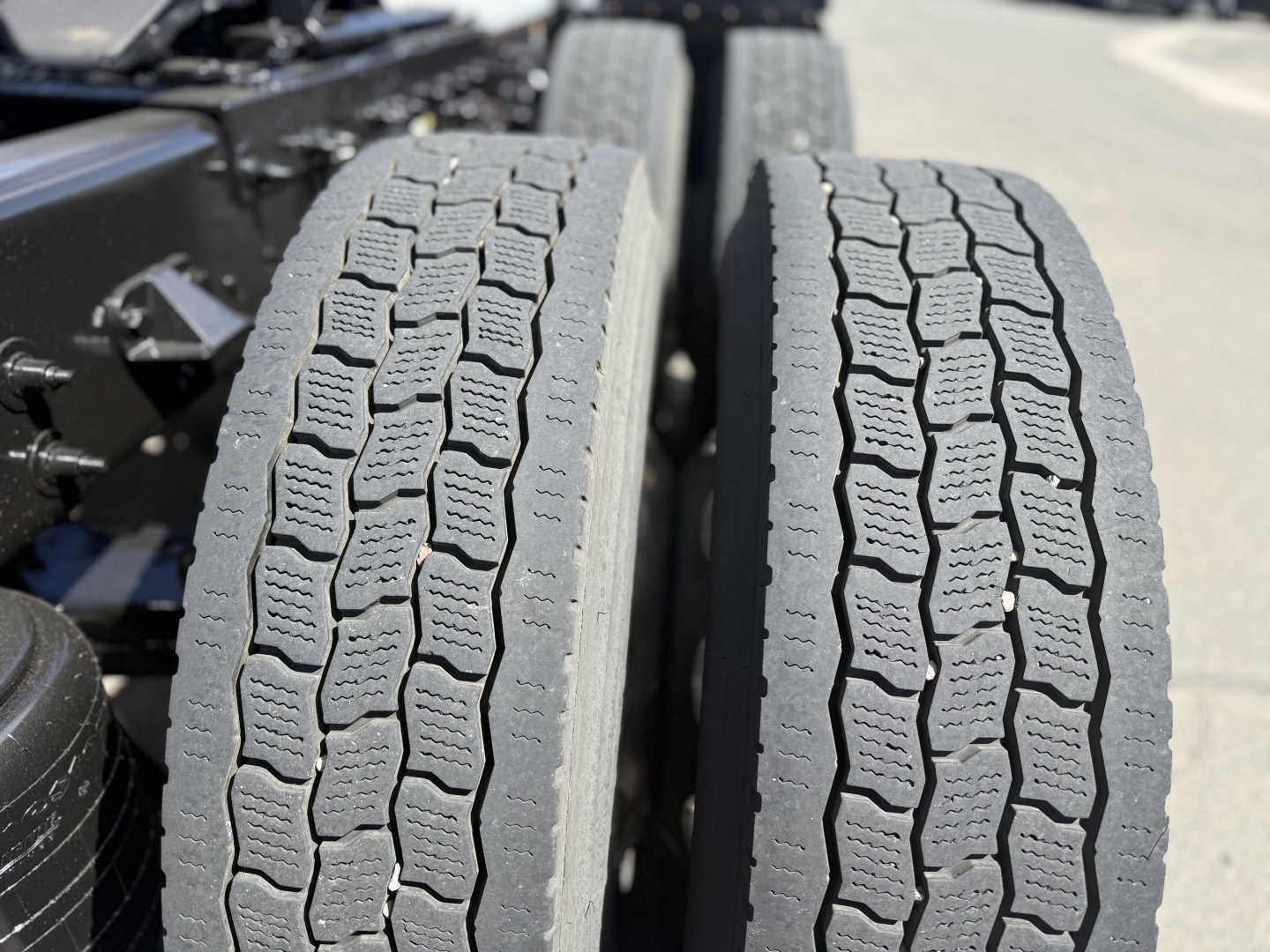 Peterbilt 389 wheel/tire tread close-up showing dual rear tires and chassis.