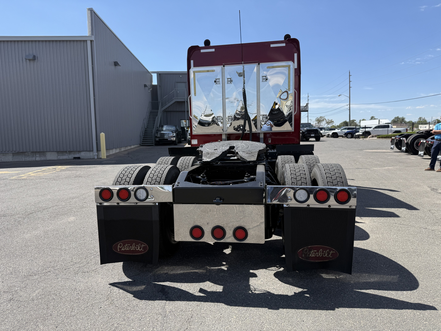 Peterbilt 389 rear view showing chassis, dual rear axles, rear bumper with Mudflaps, and fifth wheel removed; clear visibility of cab back and taillights.