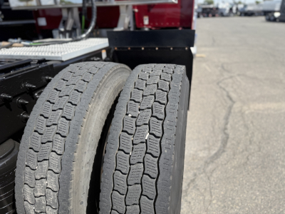 Dual rear tires of a Peterbilt 389 tractor show tread pattern and sidewall markings.