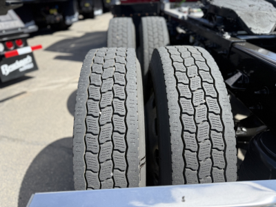 Twin rear tires of a Peterbilt 389 truck chassis with tread pattern visible and slight road grime.