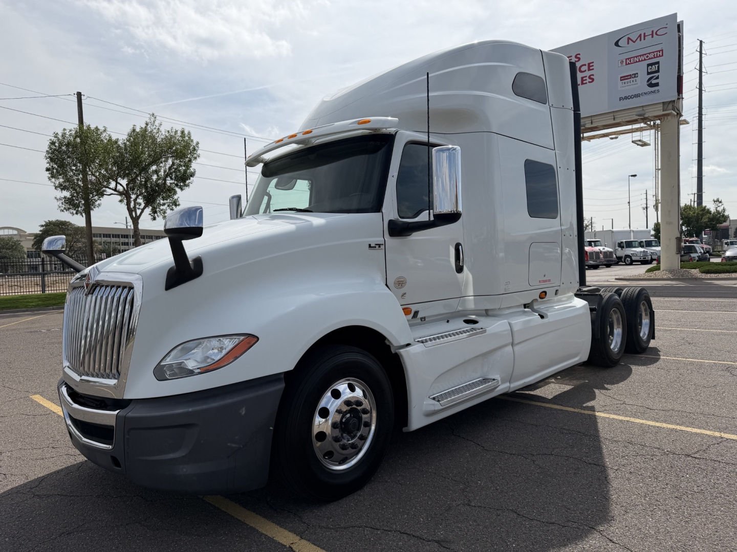 White 2019 International LT625 sleeper cab tractor in side view showing front grille, aerodynamic mirrors, and dual rear axles.
