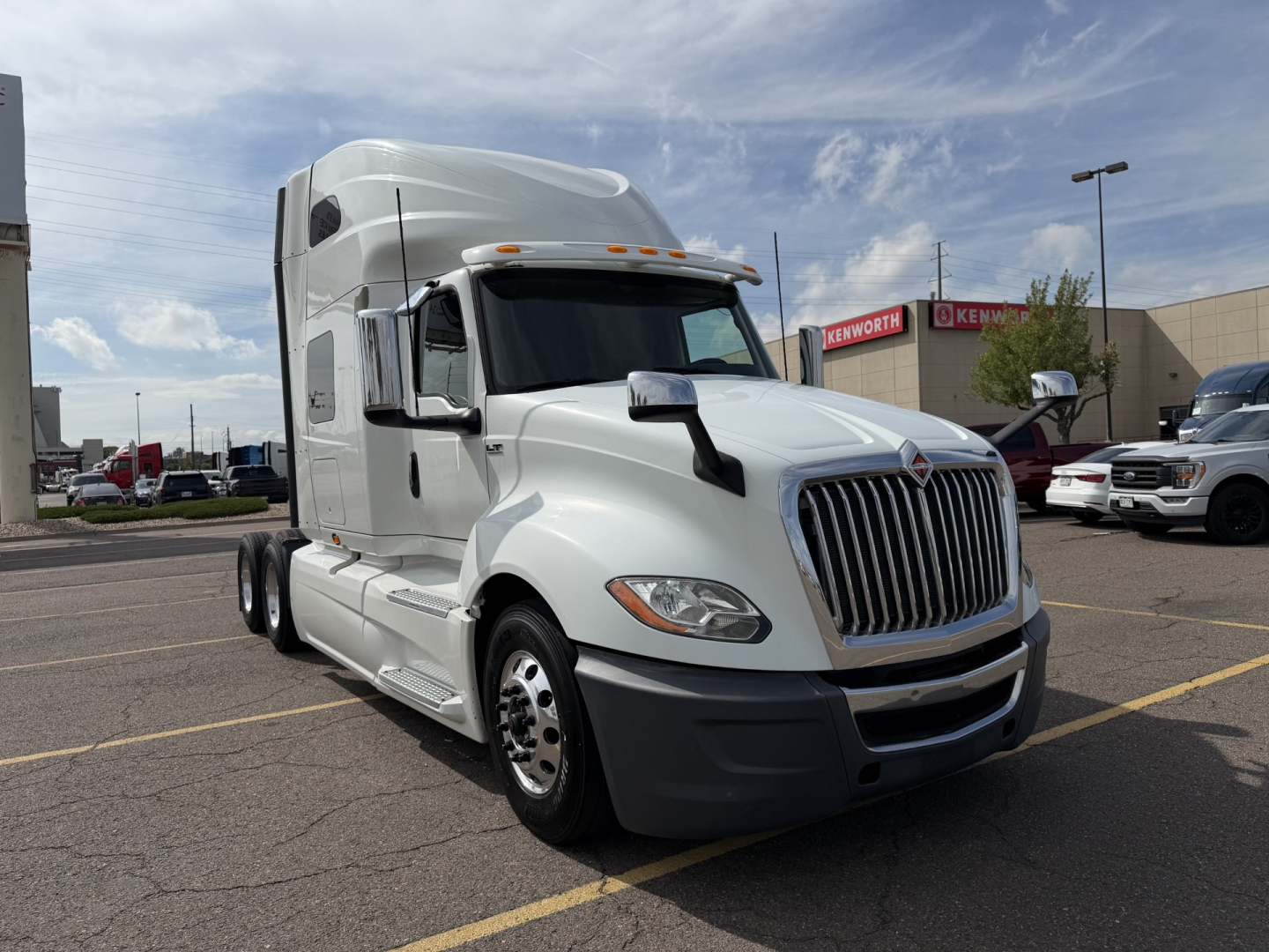 Truck cab showing 2019 International LT625 sleeper tractor with chrome grille and large windshield, front three-quarter view.