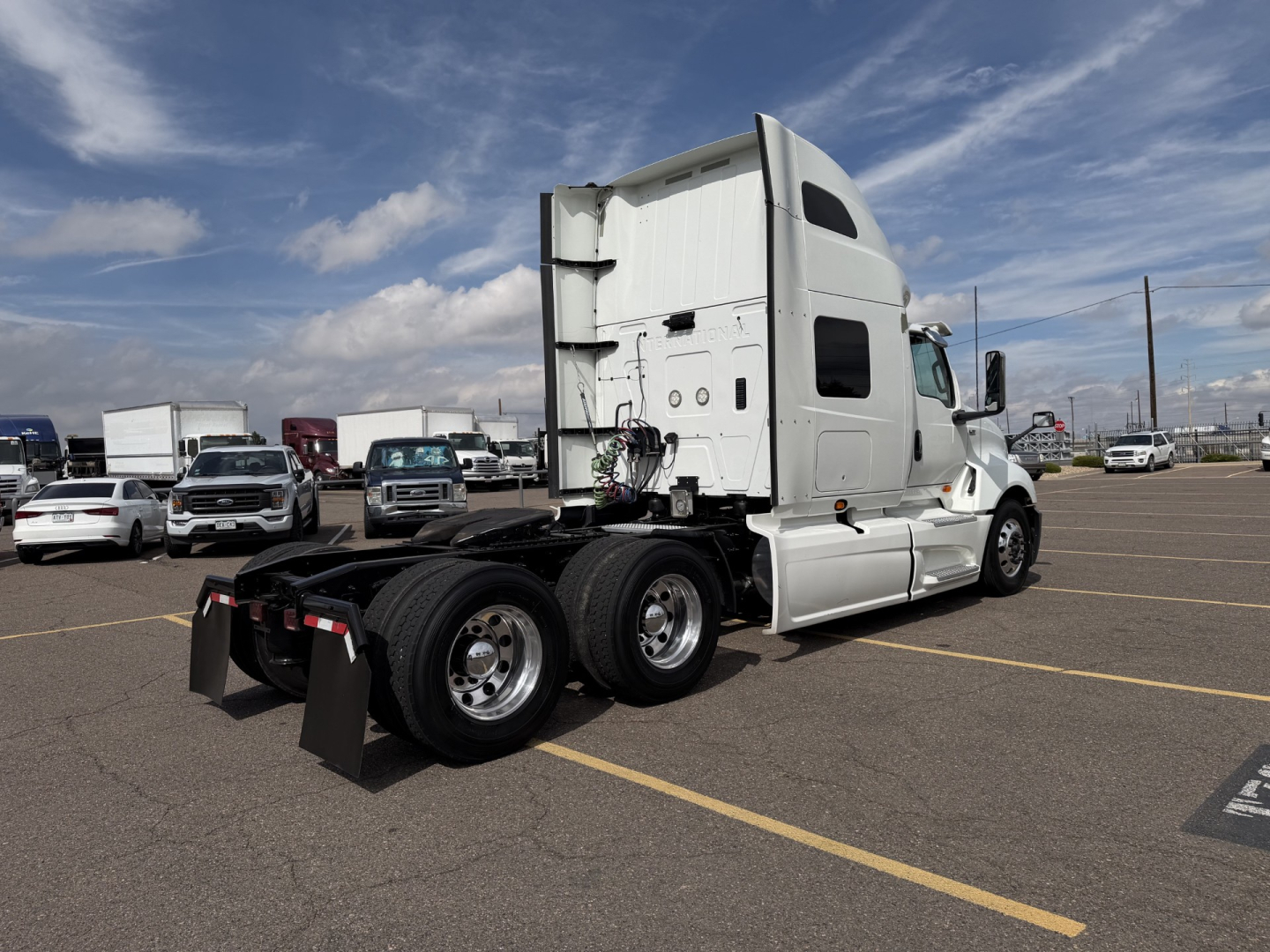 Truck tractor side/rear view showing International LT625 2019 with sleeper cab and dual rear axles.