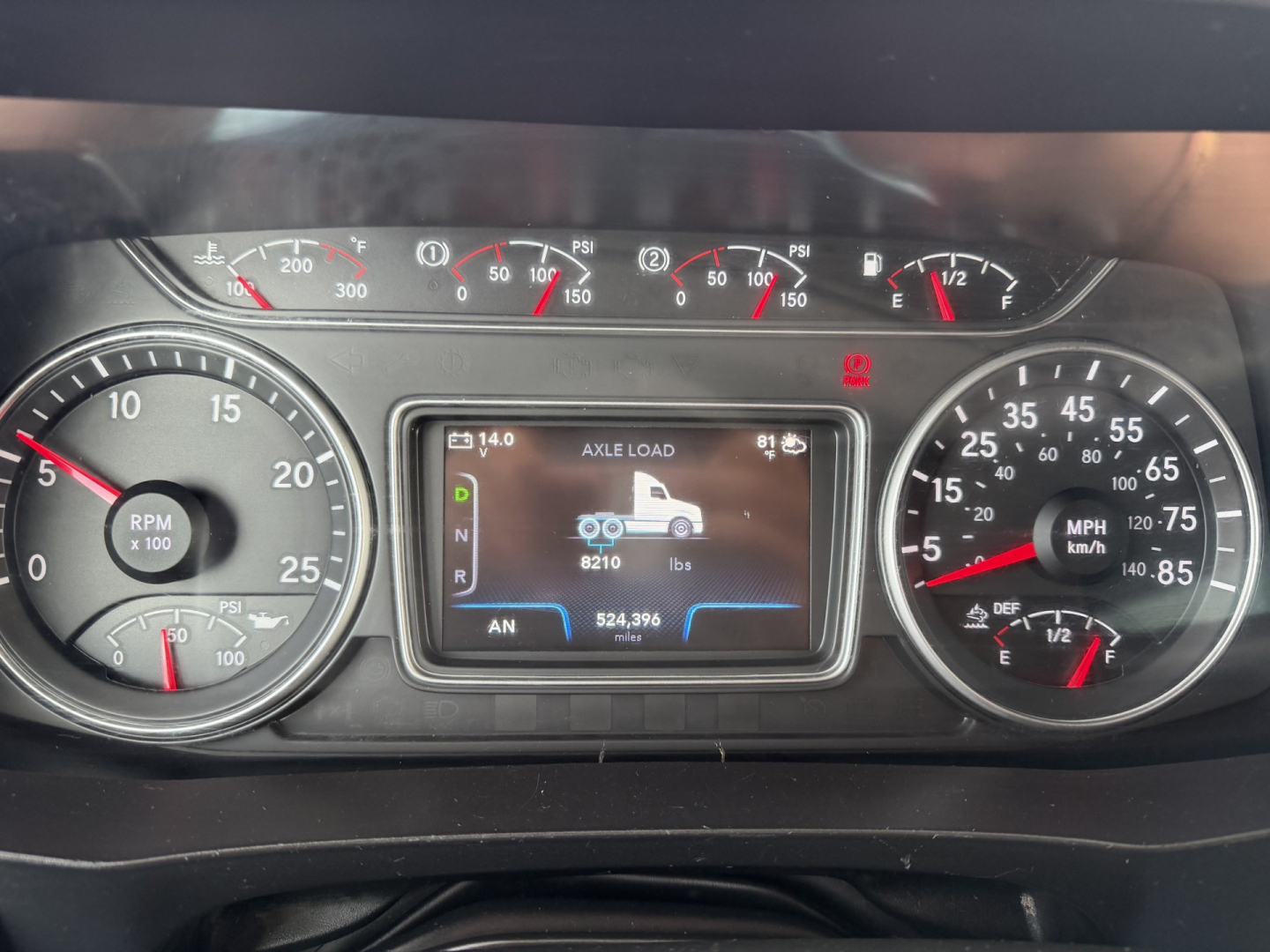 Dashboard of a 2019 International LT625 showing instrument cluster with tachometer, speedometer, and central display reading axle load and weight specs.