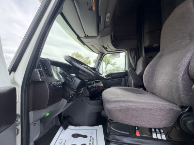 Truck cab interior showing steering wheel, dashboard, and driver seat from a 2019 International LT625. Visible text includes no clear labels but the image shows the cab area.