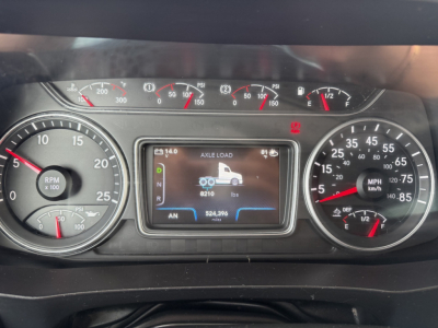Dashboard of a 2019 International LT625 showing instrument cluster with tachometer, speedometer, and central display reading axle load and weight specs.