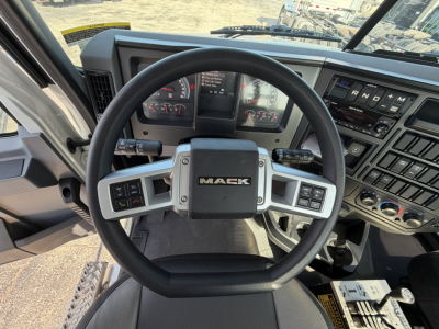 Mack GR64F truck interior steering wheel and dashboard with controls and instrument cluster visible