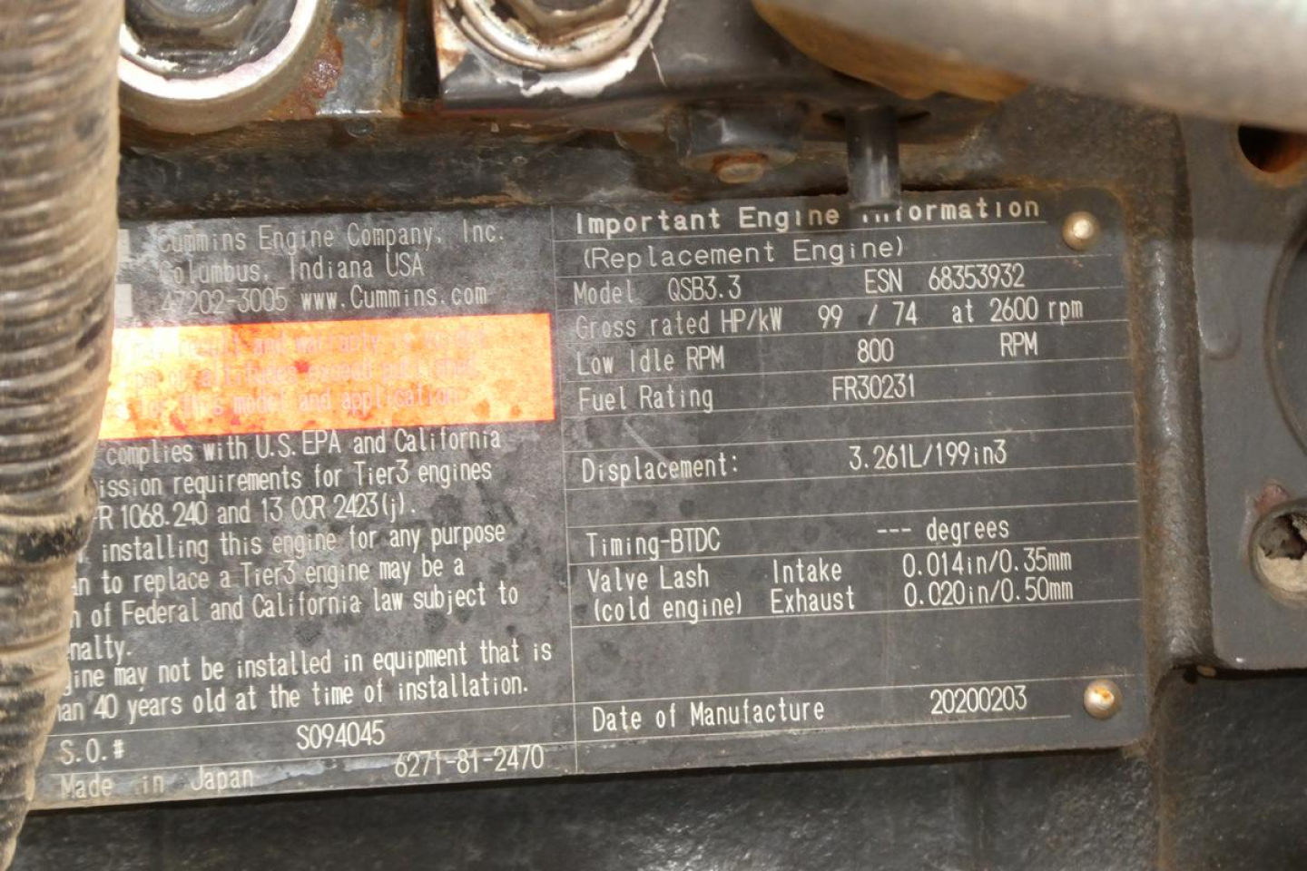 Close-up of engine identification plate on equipment, showing model and engine details including model EBHP, RPM, fuel rating, and displacement. Partial text visible near center: 'Important Engine Information', 'Model ESP3.HP? ', 'Displacem