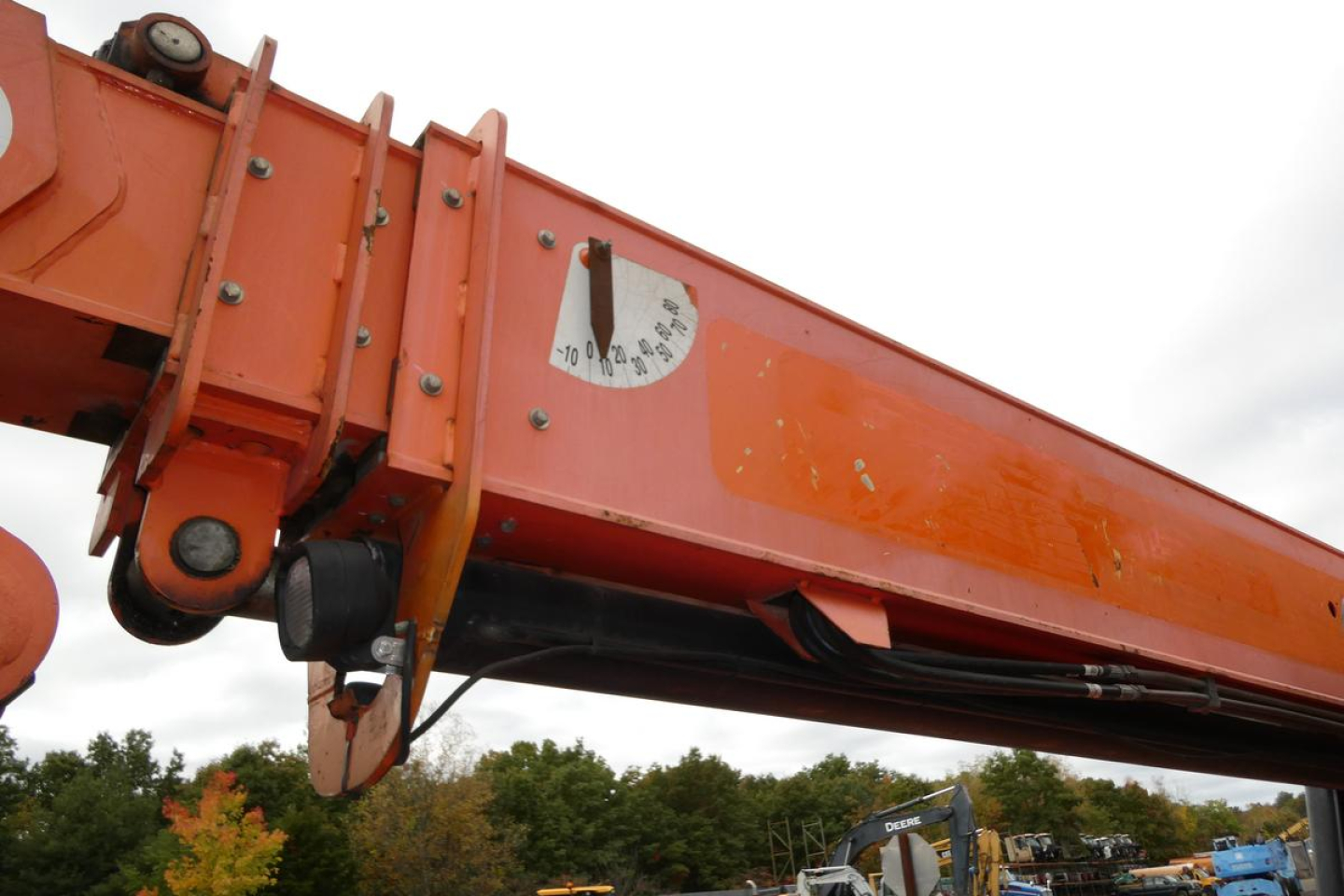 JLG 6042 telescopic boom lift component with orange paint and hydraulic joints visible.
