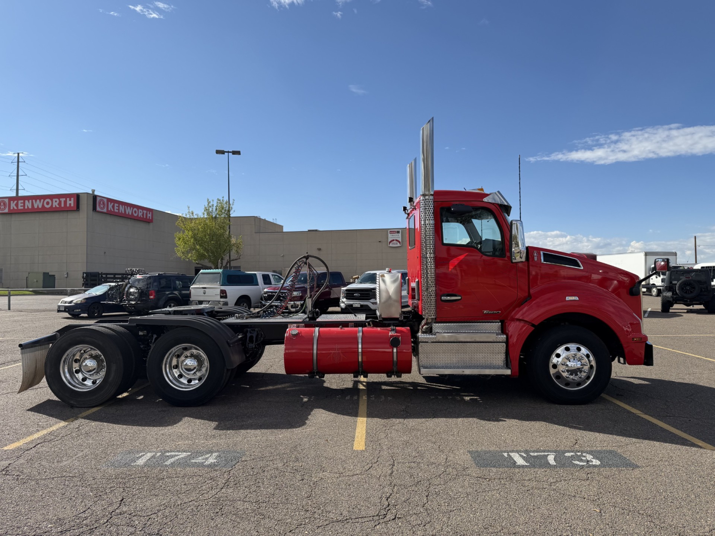 Kenworth T880 conventional daycab truck in red, side view, with chassis and fuel tanks visible; VIN 1XKZDP9X1LJ428490 and stock #0632453 present in listing.